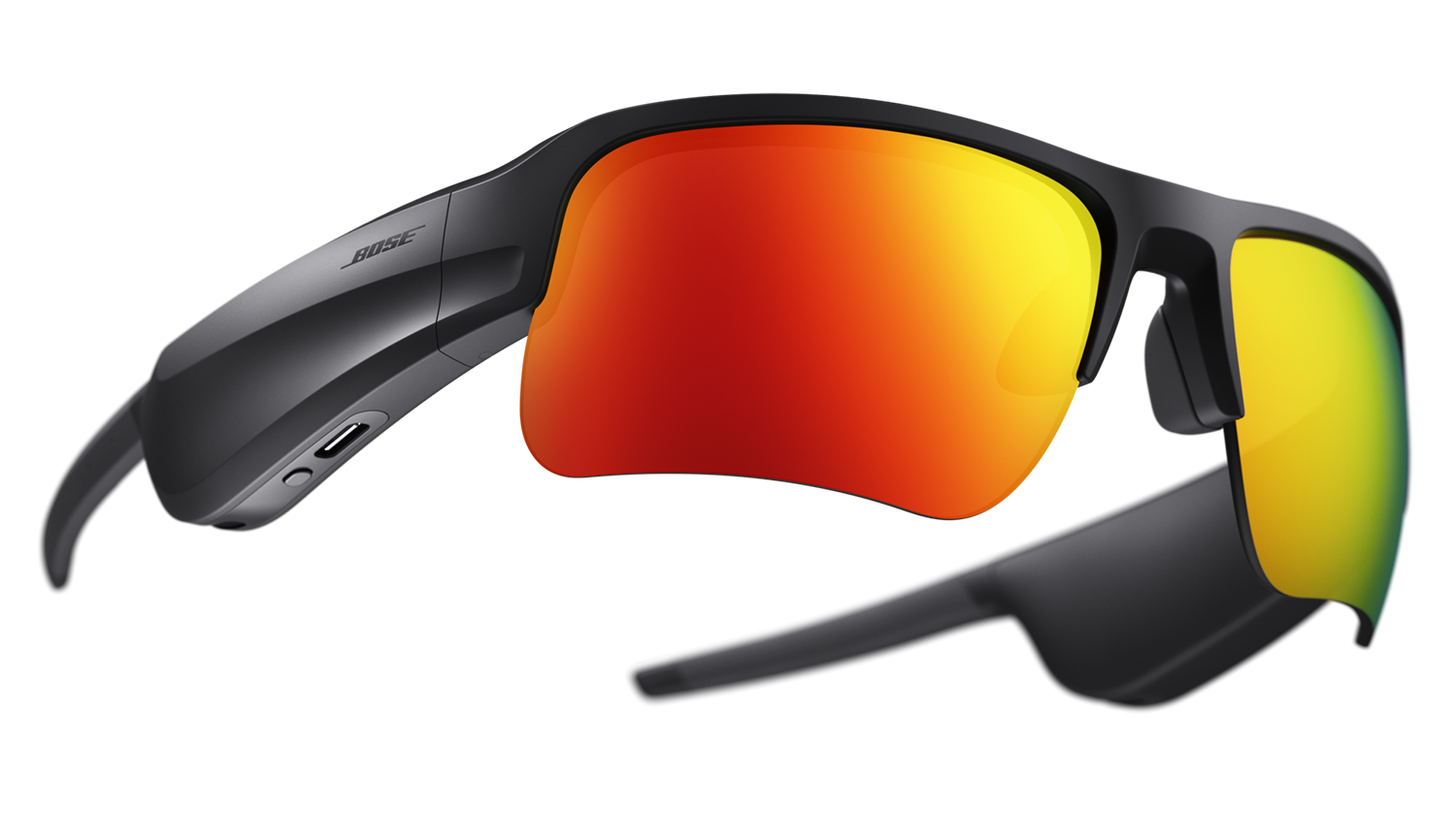 Bose sunglasses with red lenses and black frames. The glasses are angled and on a black surface.