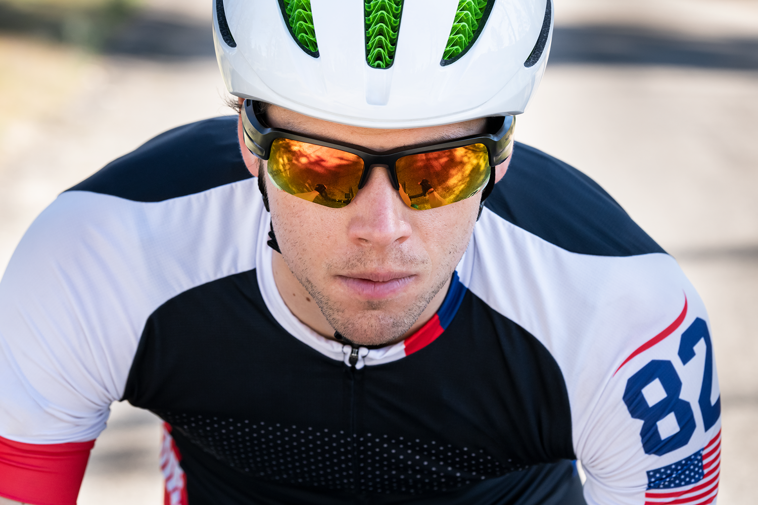 A cyclist wearing sunglasses and a helmet, top down view.