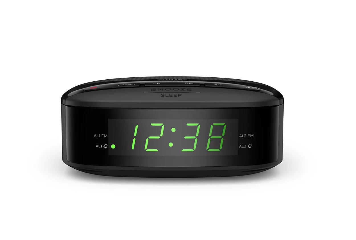 A black digital alarm clock showing the time 12:38 in green digits on the display.