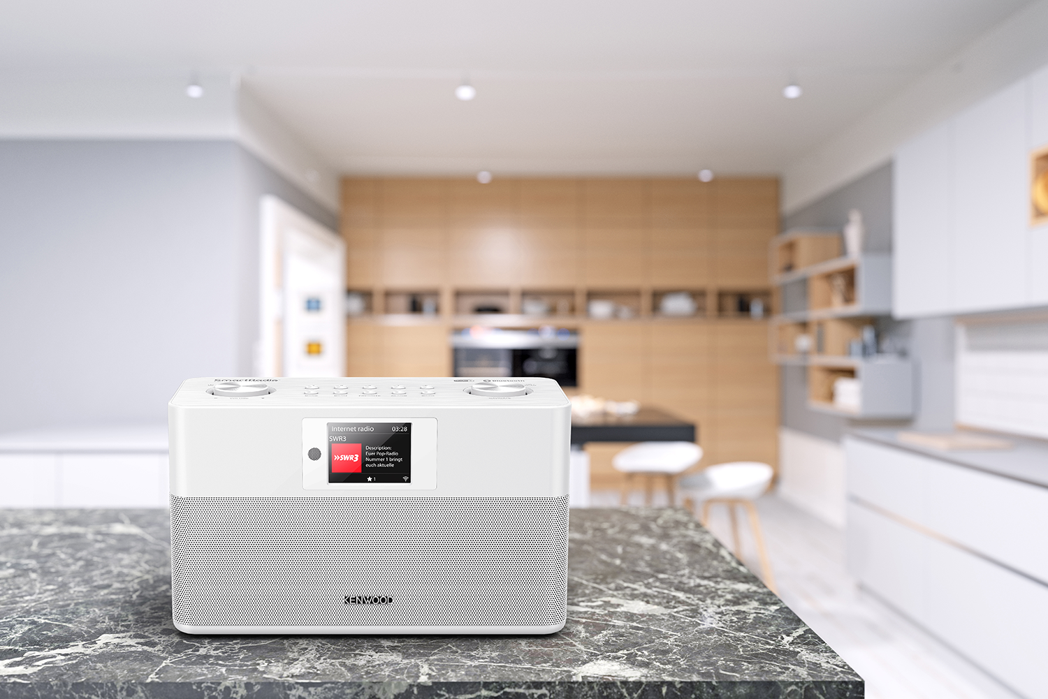 A white Kenwood radio on a kitchen countertop.