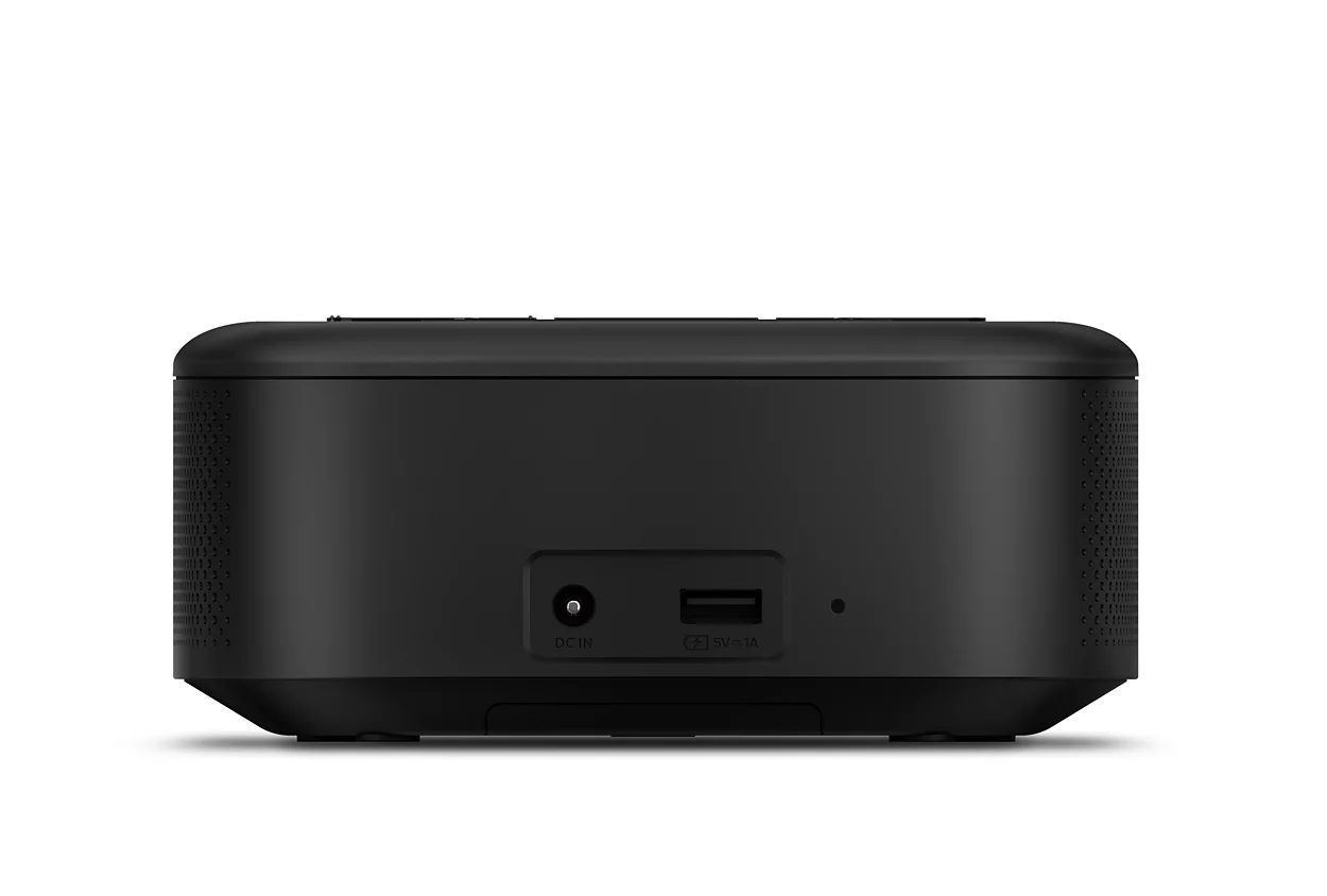 Black speaker with a power port and USB port on its back, white background.