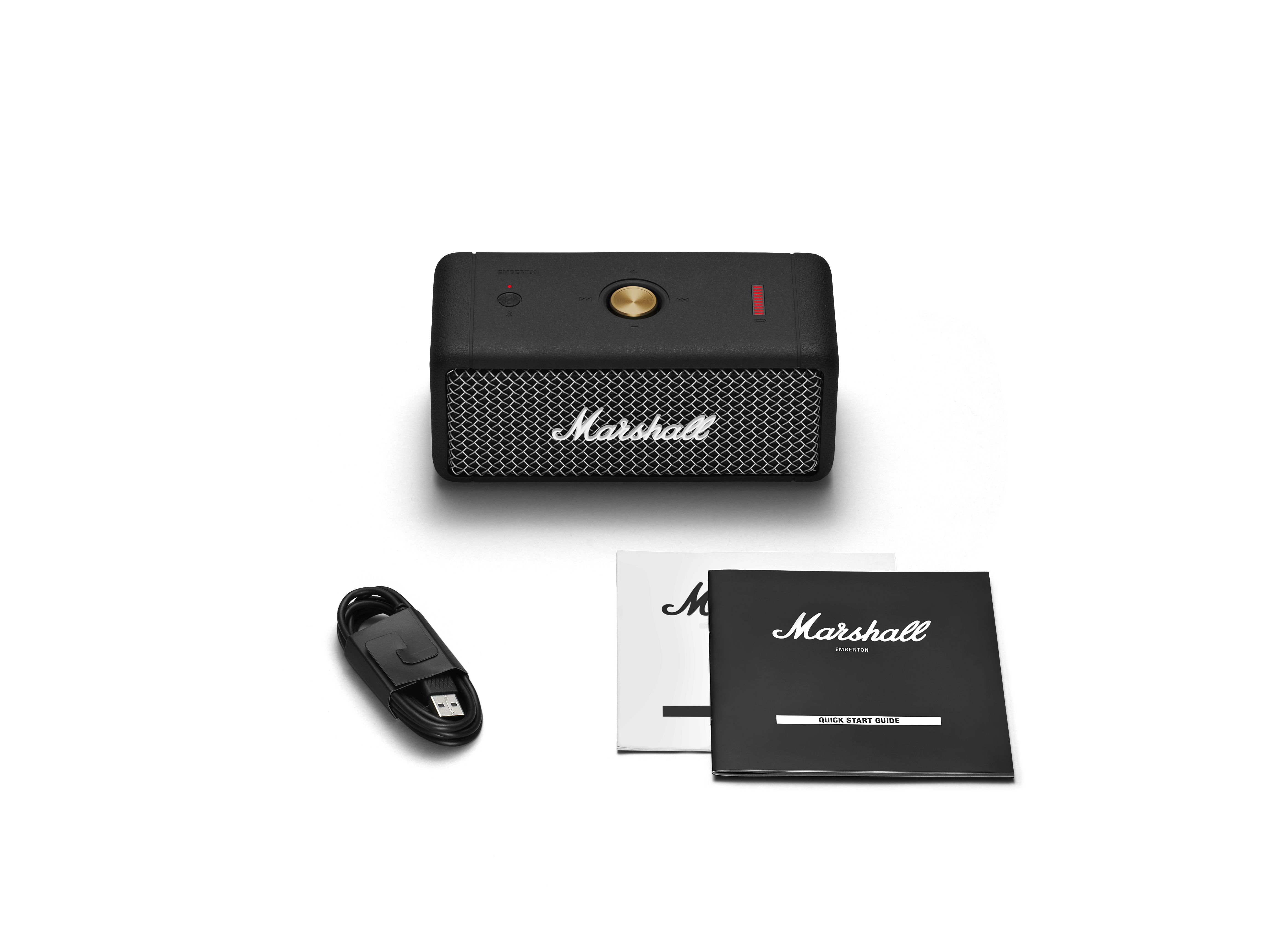 Schwarzer Marshall-Lautsprecher mit weißem Mesh und goldenen Akzenten, mit USB-Kabel und Handbüchern auf weißem Hintergrund.