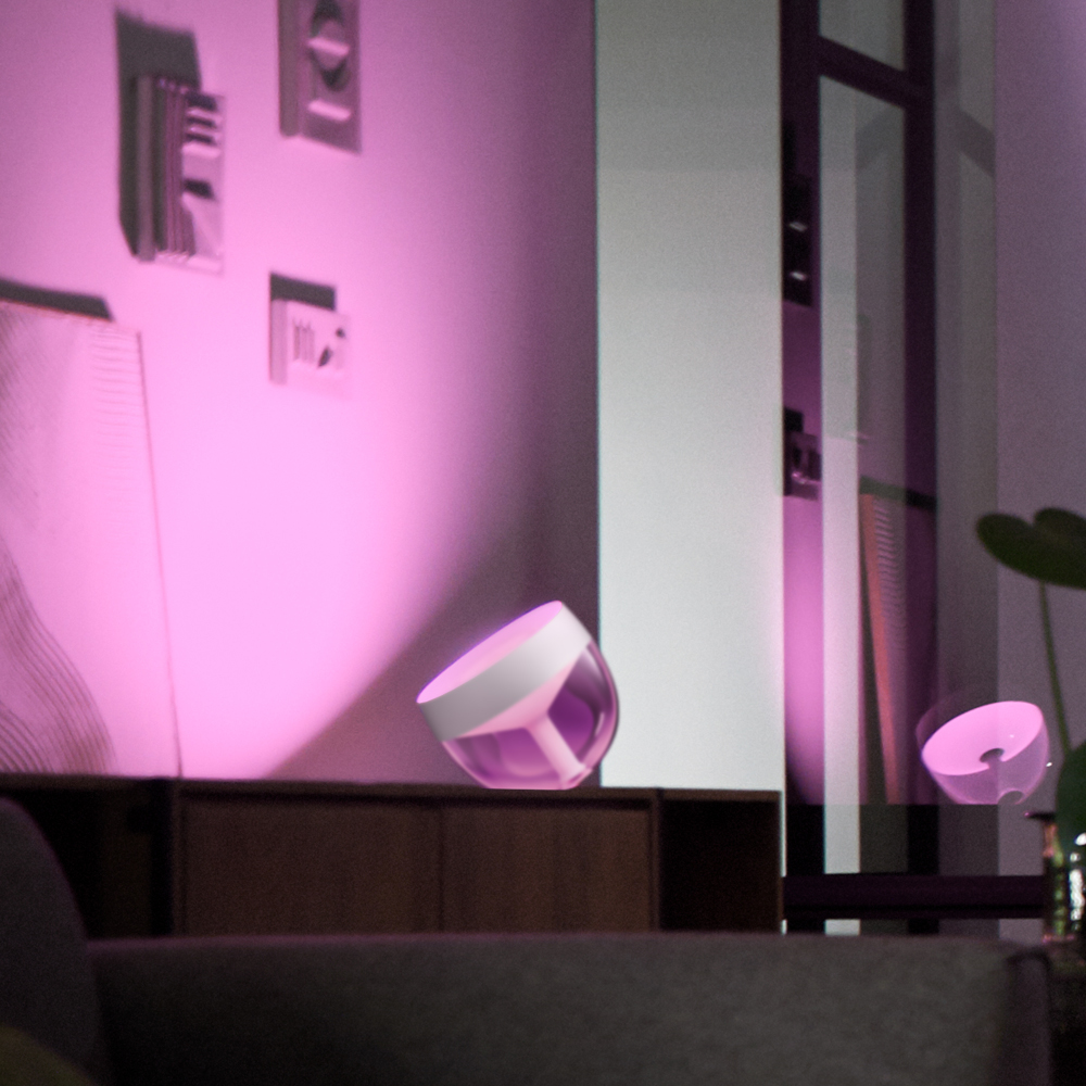 Pink light fixture in a room, casting light on objects.