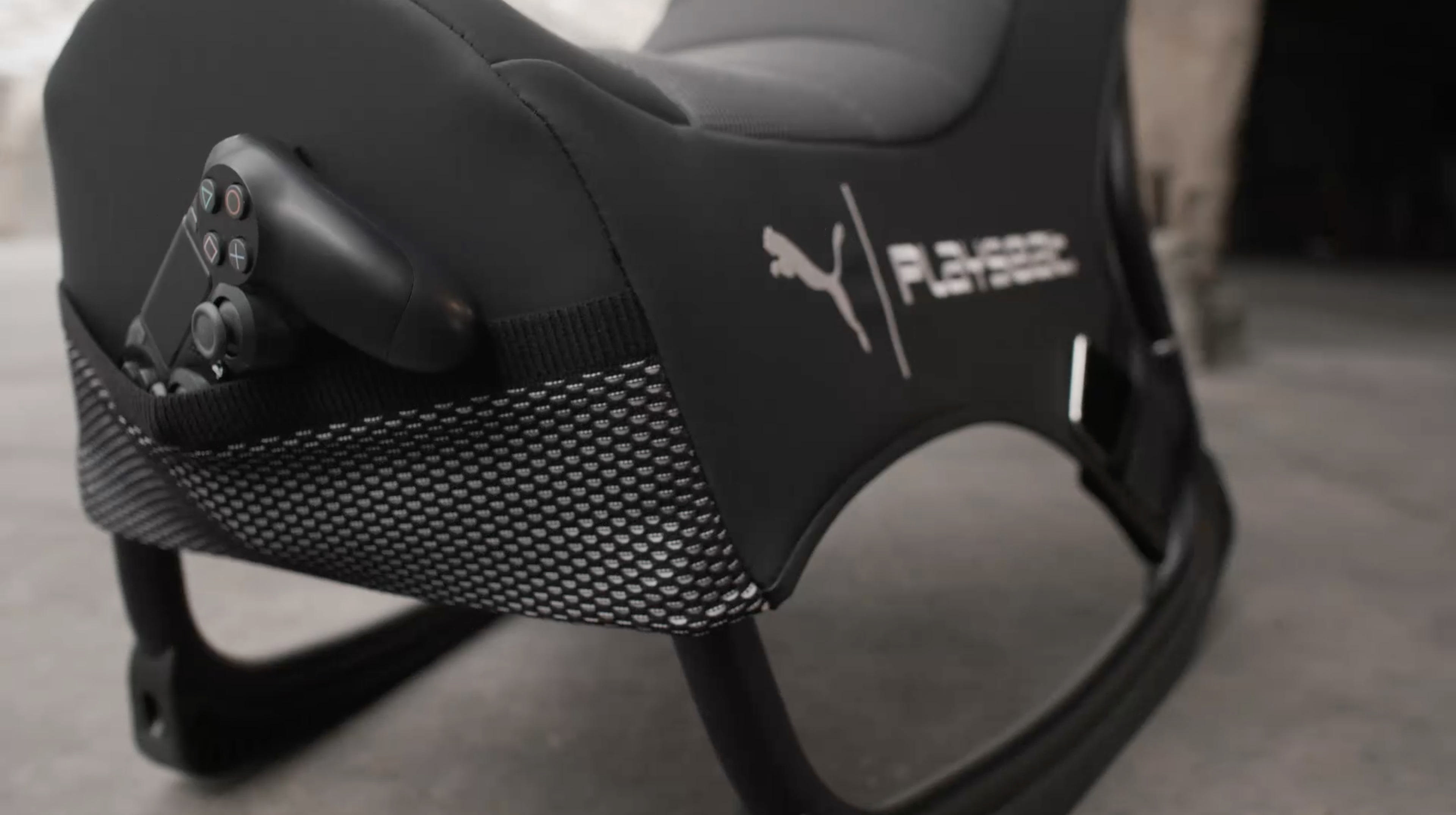 Schwarzer Gaming-Stuhl. Controller in der Tasche. Puma-Logo. Schaukelstuhl-Design.