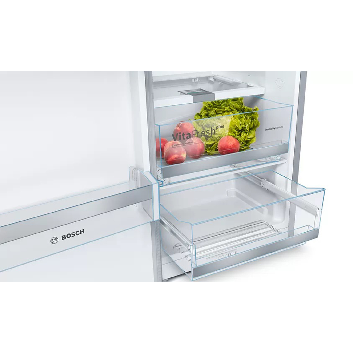 Refrigerador abierto con cajones transparentes. Melocotones y lechuga en el cajón superior, vacío abajo.