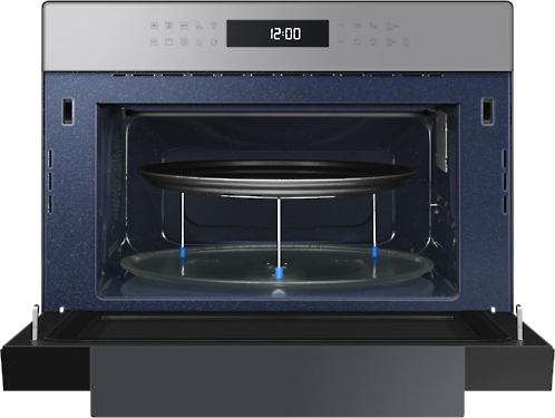 Interior of a microwave. A tray and a glass plate are inside. The time is displayed.