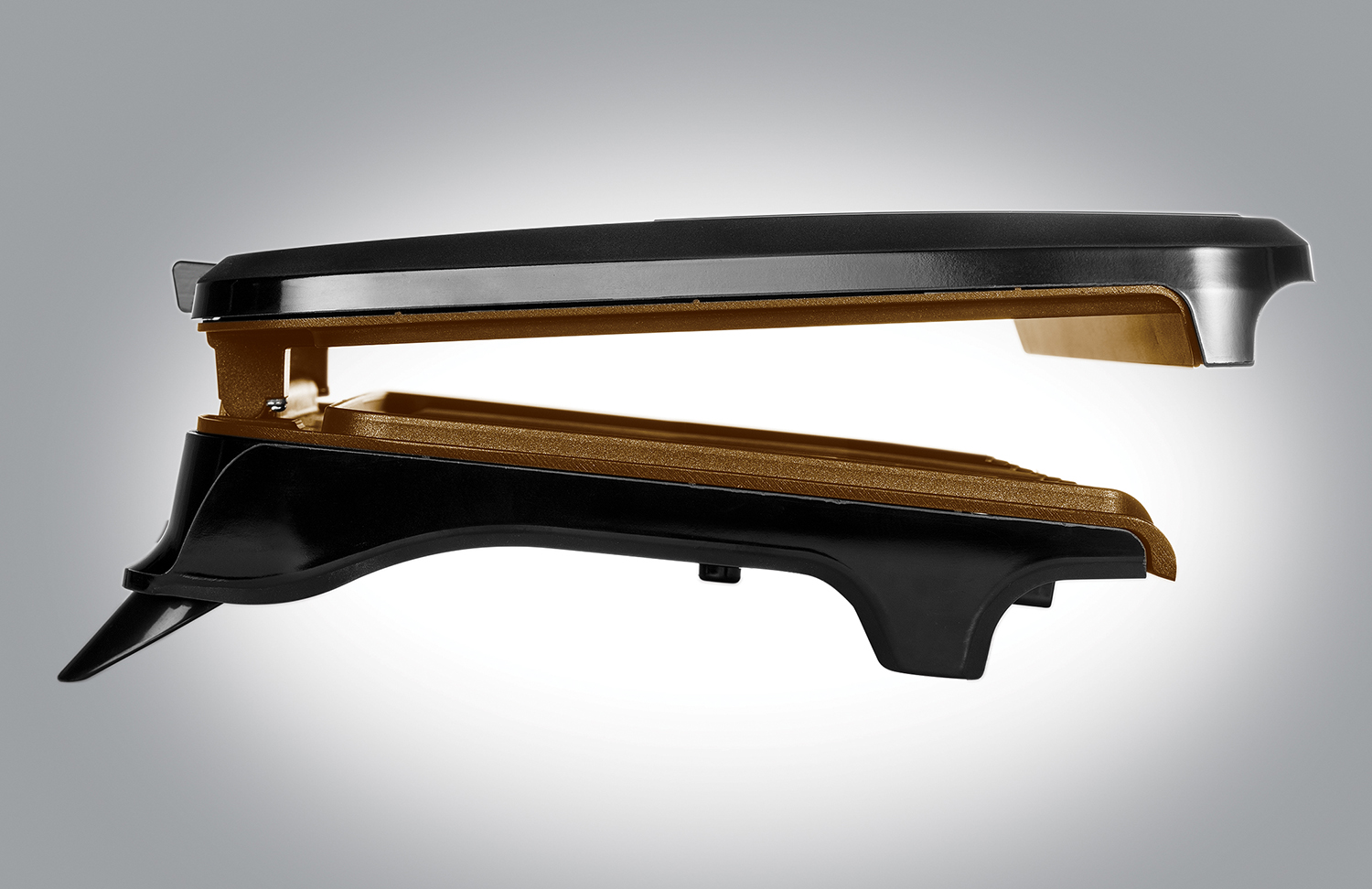 Black and brown electric griddle with open lid on grey surface.