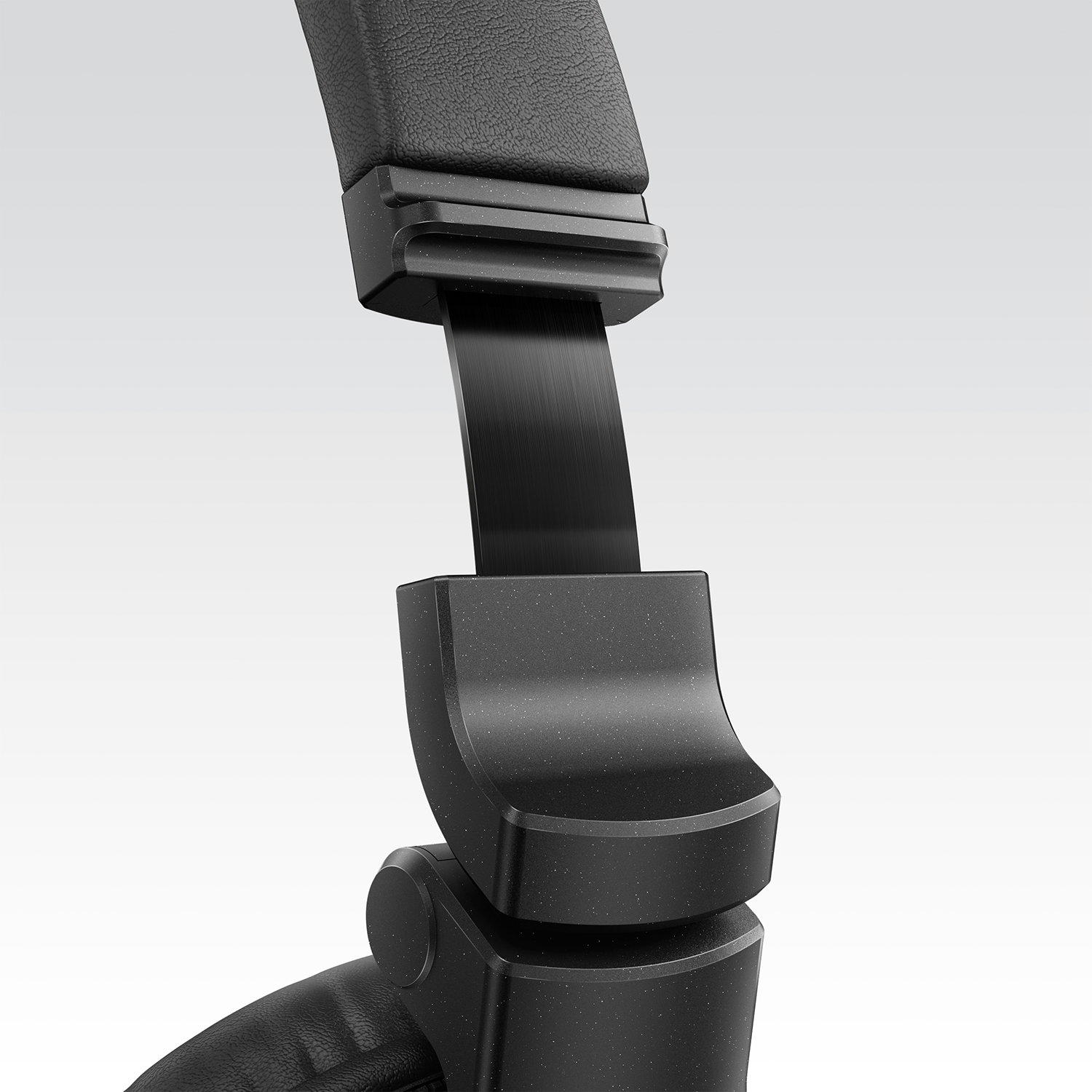Close-up of a black headphone hinge, showing the joint and the headband.