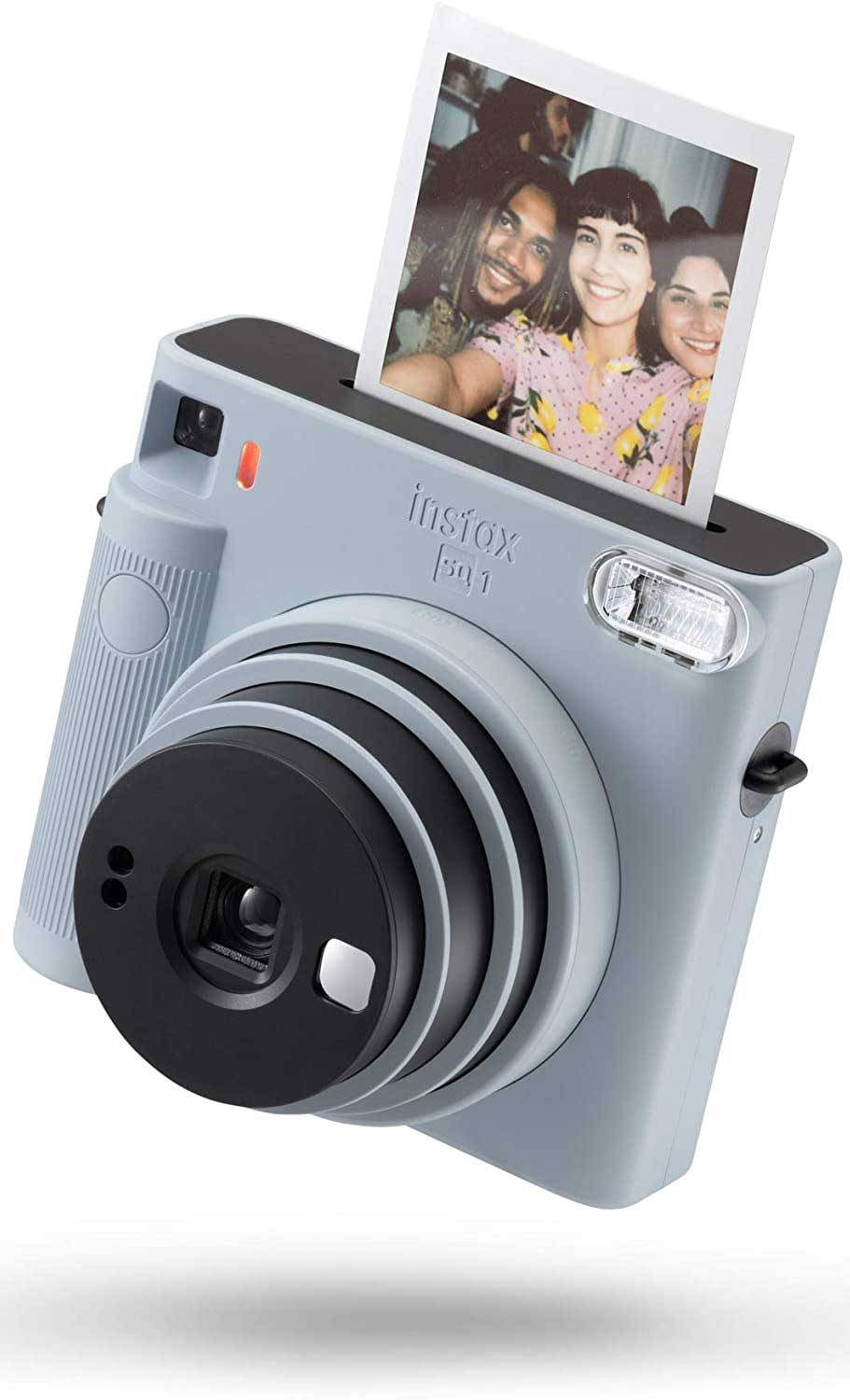 A light blue Instax SQ1 instant camera, with a photo being ejected from the top.