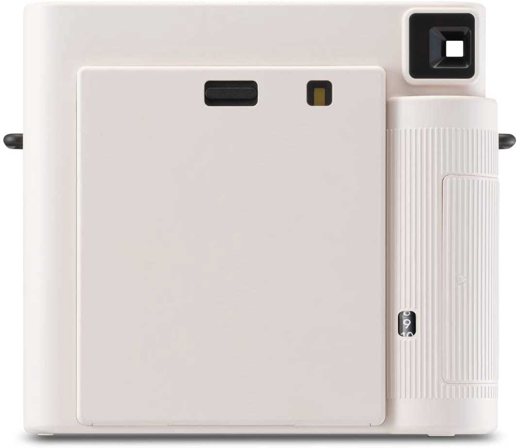 White instant camera with a black lens and a power button.