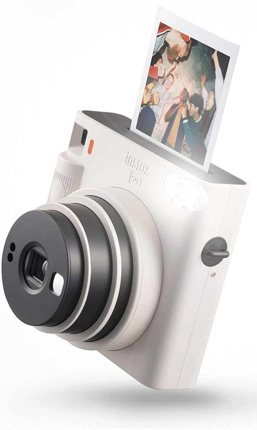 White Instax camera with a photo being ejected. Photo shows group of people with drinks.