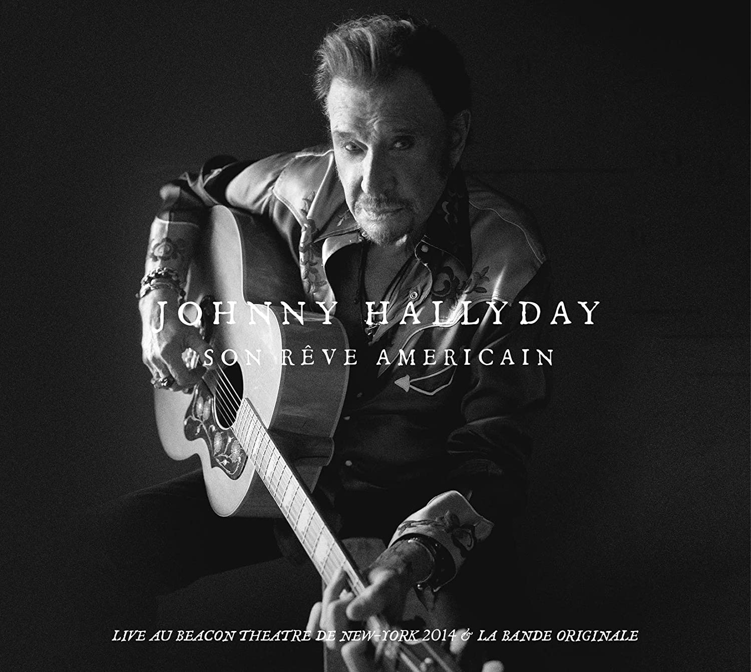 Black and white album cover. Johnny Hallyday plays guitar, dark background.