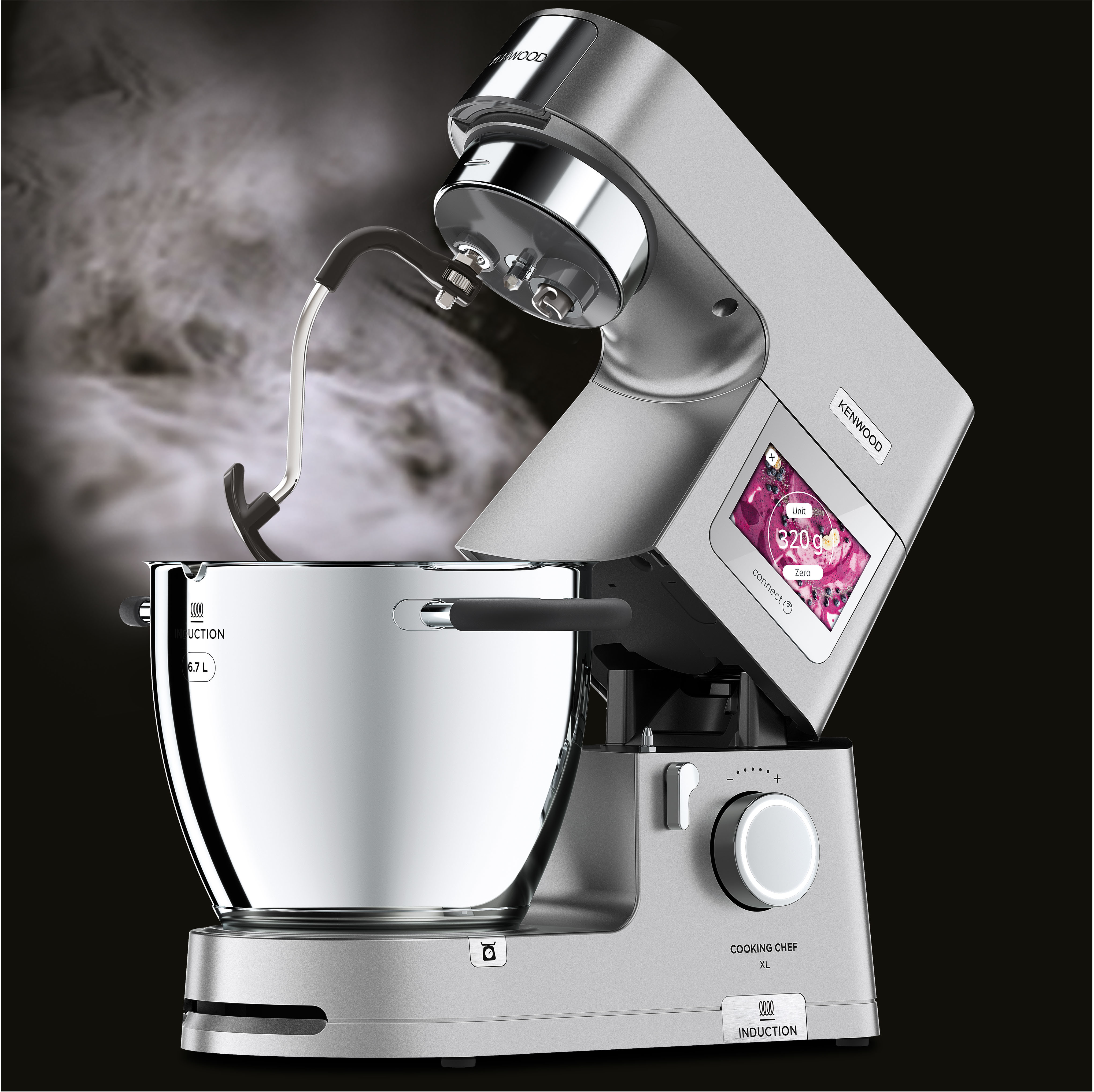 Robot da cucina argentato con vapore che sale da una ciotola. Un display digitale è sul lato.