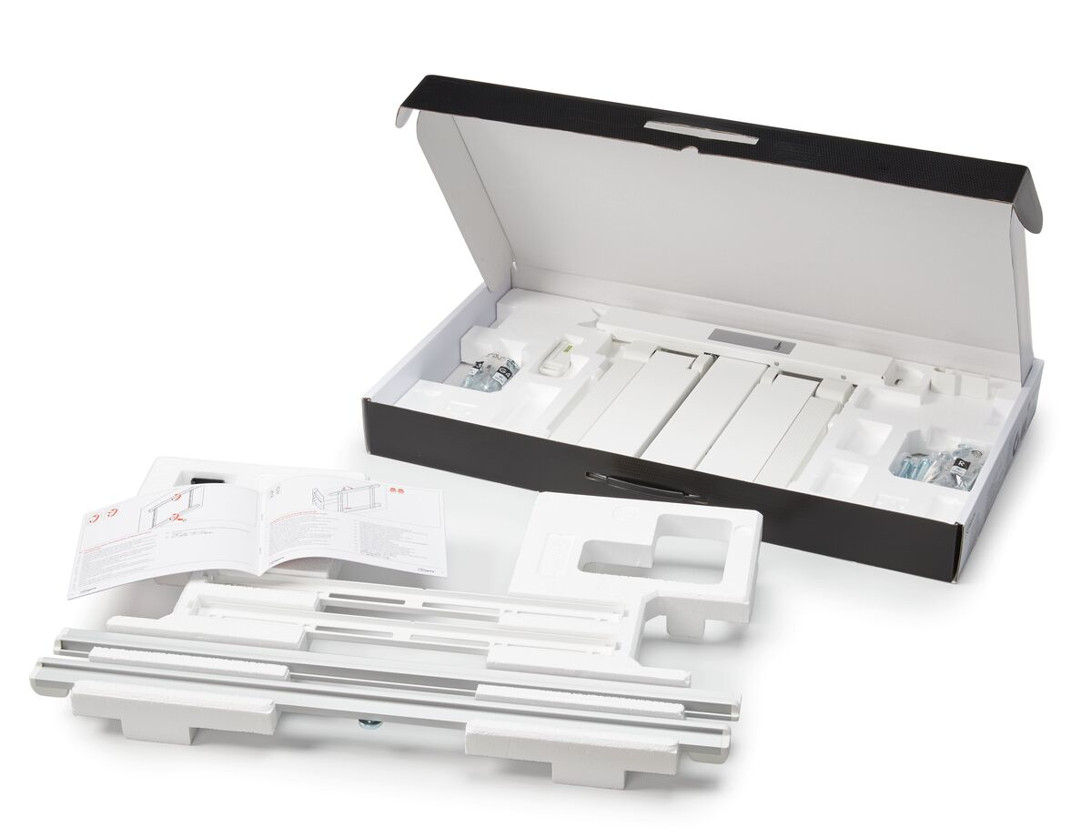 Geöffnete Box mit weißen Gegenständen im Inneren. Enthält Teile zur Montage, mit Bedienungsanleitung. Schaumverpackung.