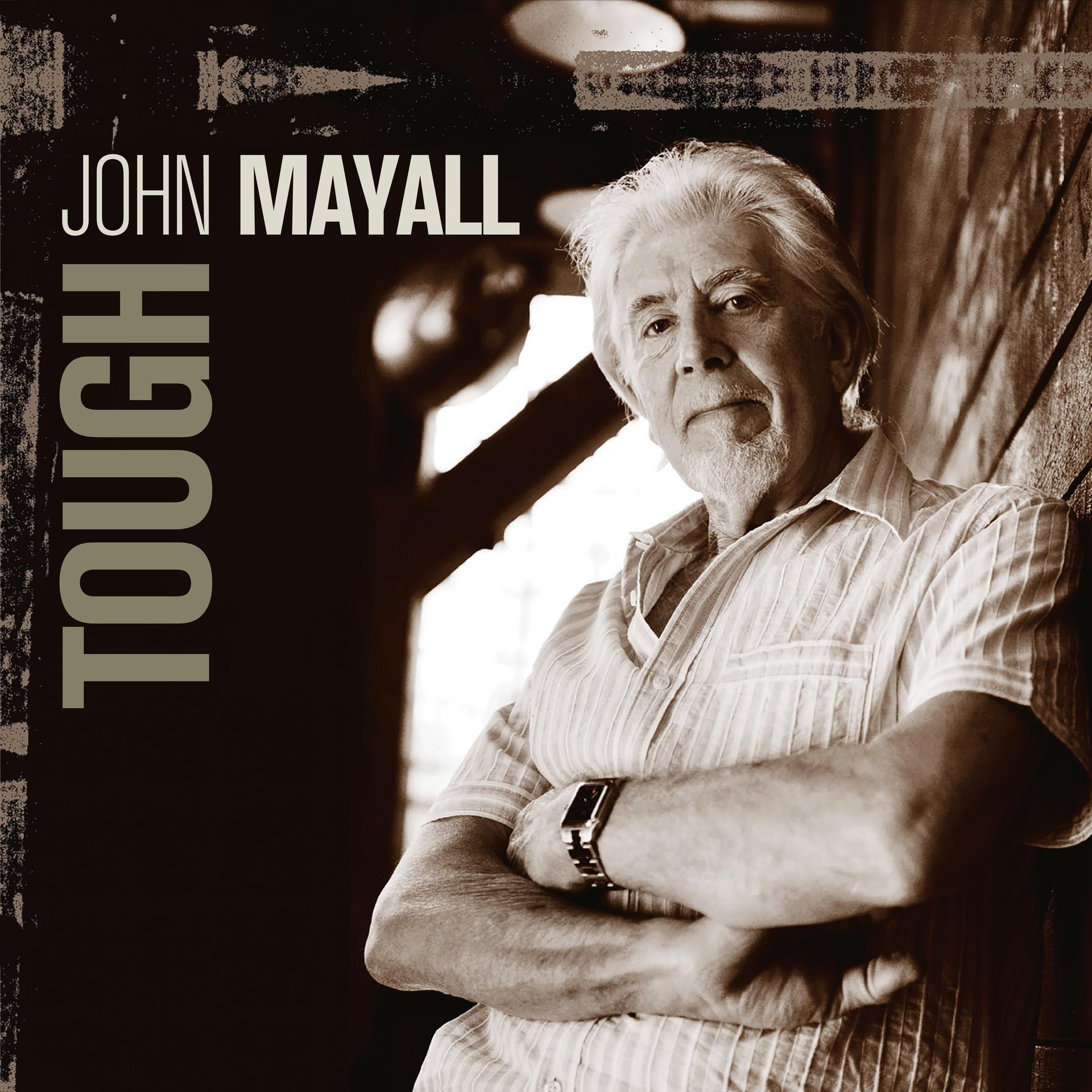 John Mayall album borítója. Szürke hajú férfi képe, karba tett kézzel. A cím 'Tough'.