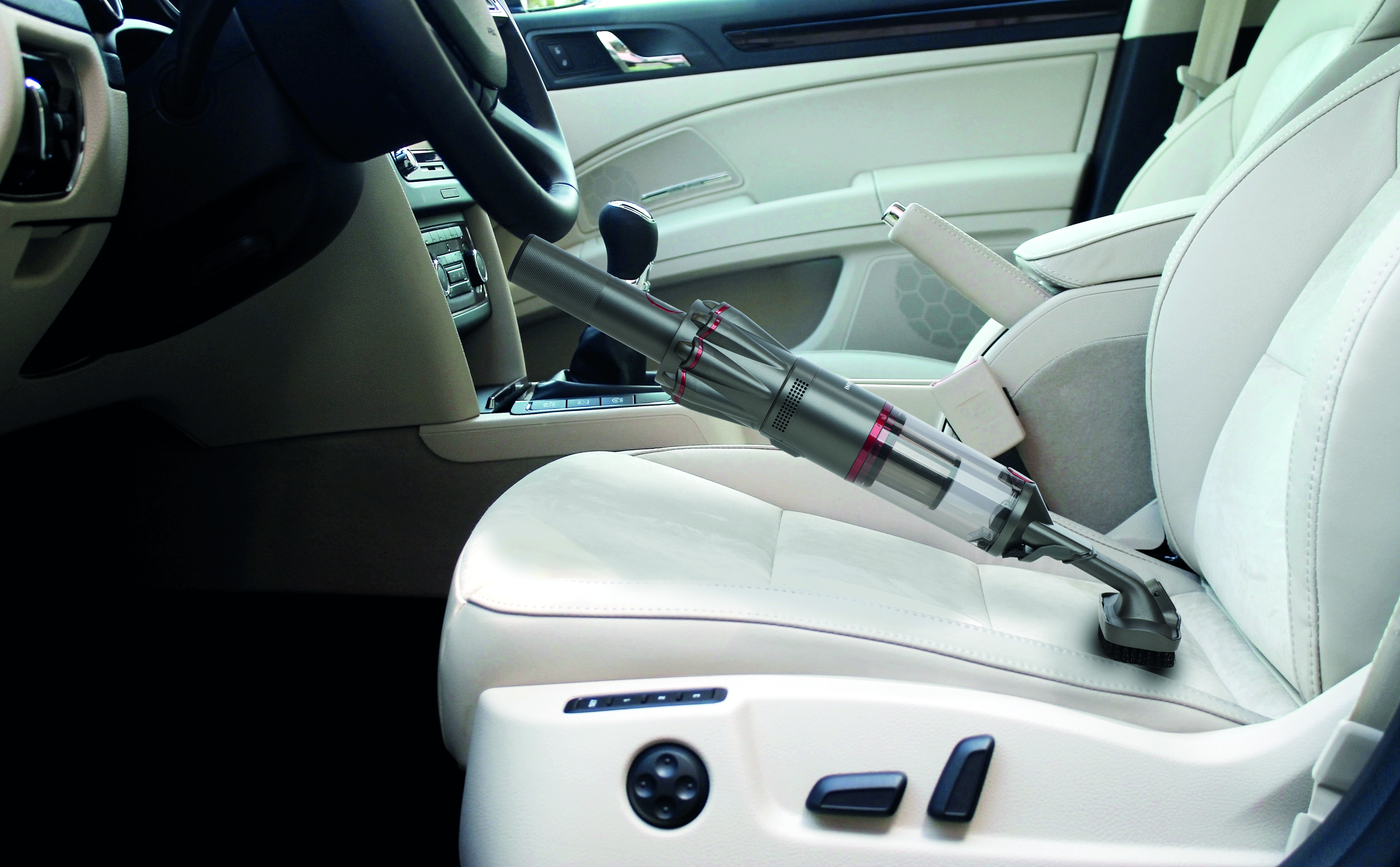 Cordless vacuum cleaner in a car's interior. Cleaning the white car seat.