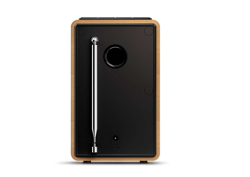 Back of a wooden radio. Black panel, antenna extended, and connection ports visible.