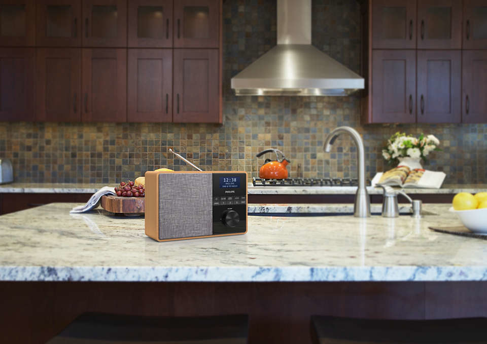 Wooden radio on a kitchen counter with a blurred background.