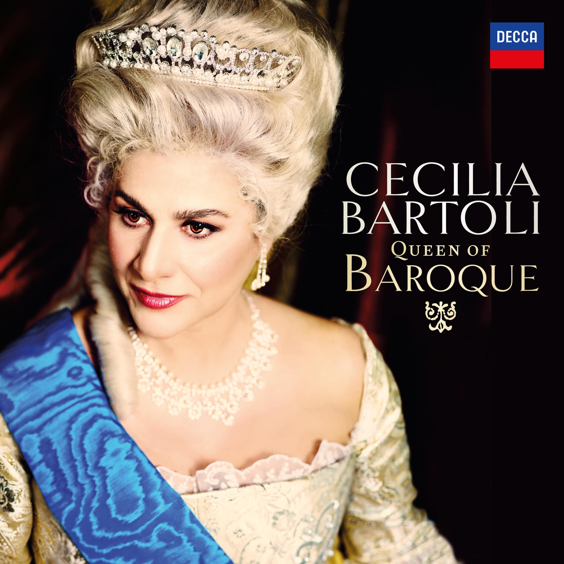 Cecilia Bartoli, Queen of Baroque, album cover. Woman with a crown and necklace, wearing a blue sash.