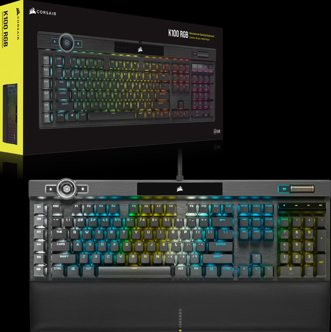 Un clavier gaming Corsair K100 RGB noir avec touches rétroéclairées colorées, boîte en arrière-plan. Les touches sont visibles.