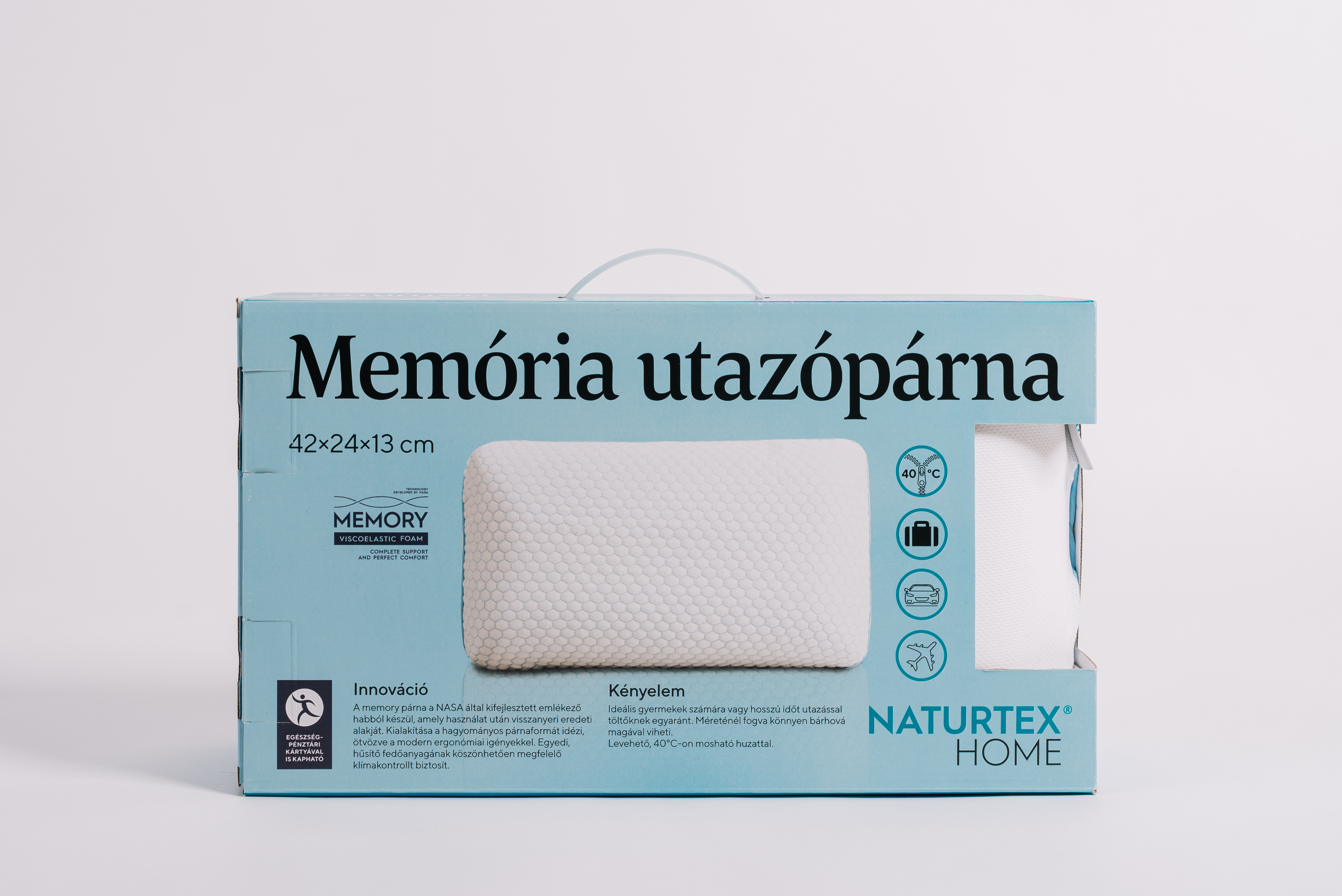 Párna egy kék dobozban, a 'Memória utazópárna' felirattal fehér háttéren.