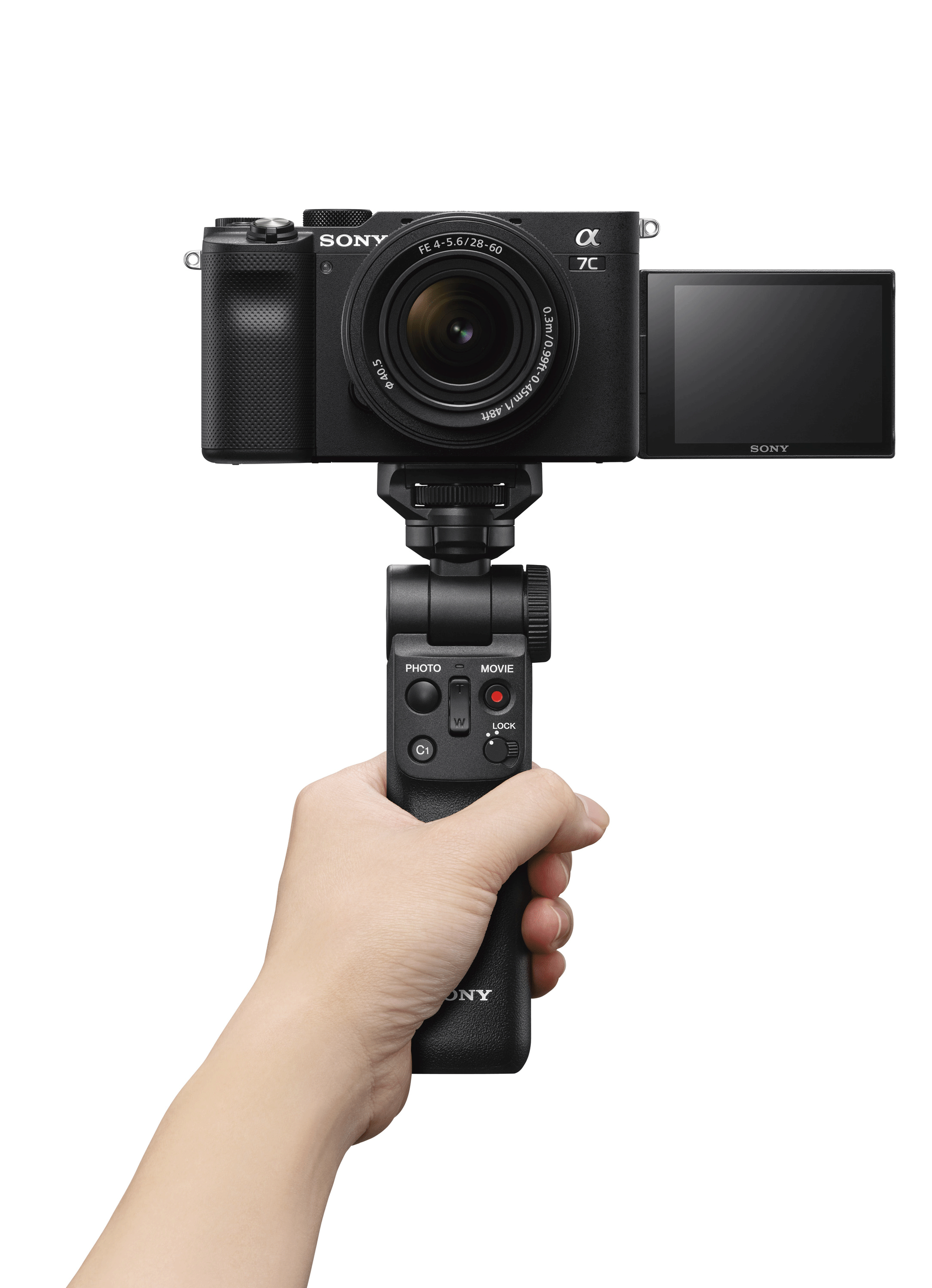 Black Sony Alpha 7C camera on a gimbal, held by a hand. The screen is open.