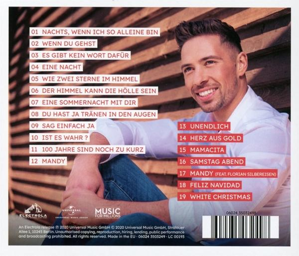 Albumcover mit einem lächelnden Mann und Text.