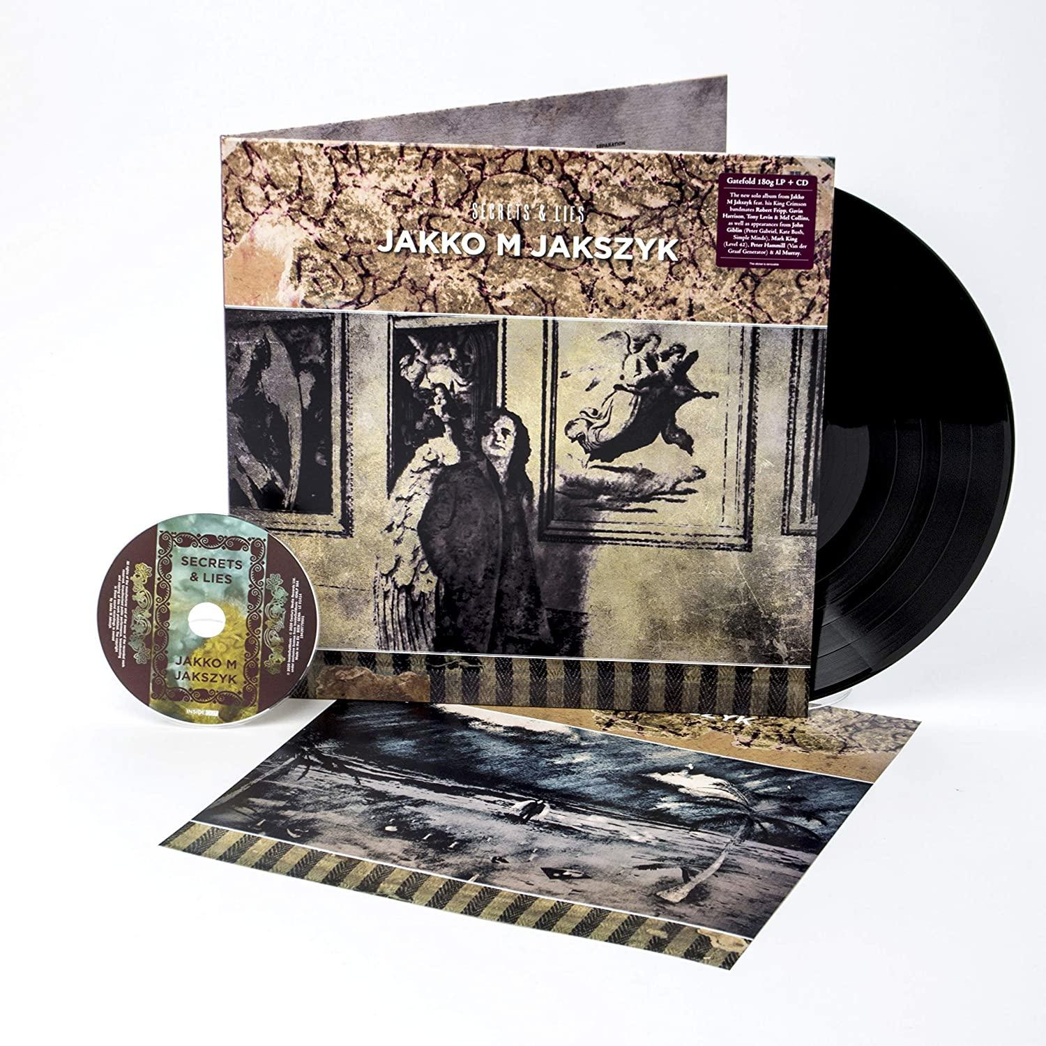 Albumcover und CD von 'Secrets & Lies' von Jakko M. Jakszyk mit einer Schallplatte.