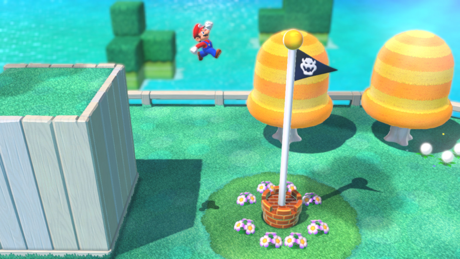 Mario springt naar een doelpaal. De scène is een kleurrijk level uit een videogame.