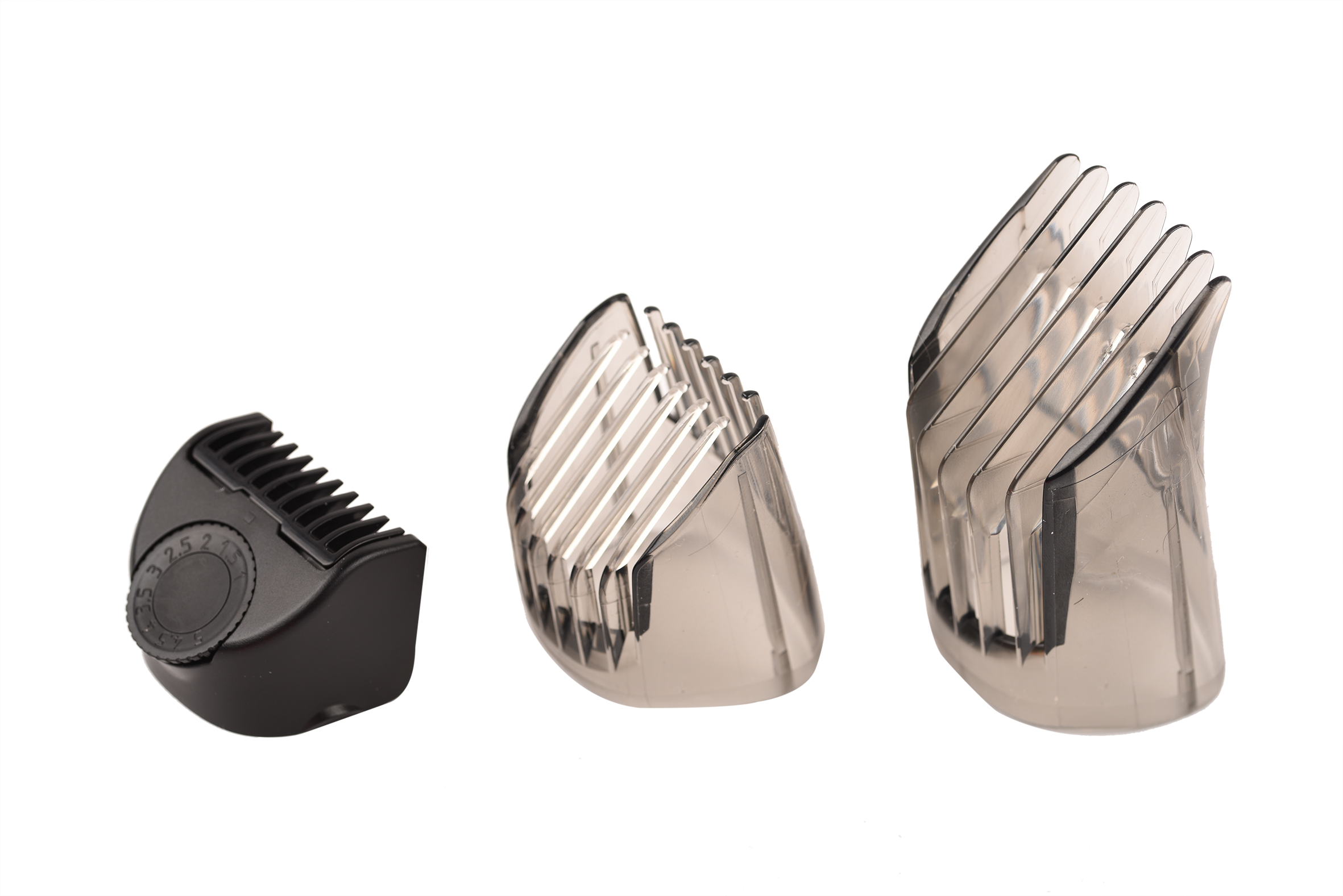 Three hair clipper attachments, black and transparent. Different sizes and shapes, on a black background.