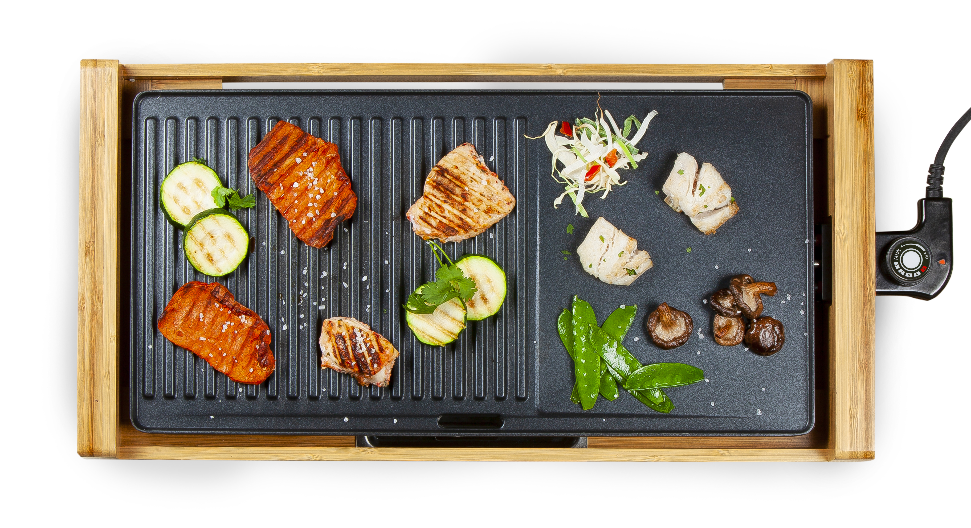 Electric grill with cooked food: salmon, zucchini, mushrooms, sprouts. Wooden frame, white background.