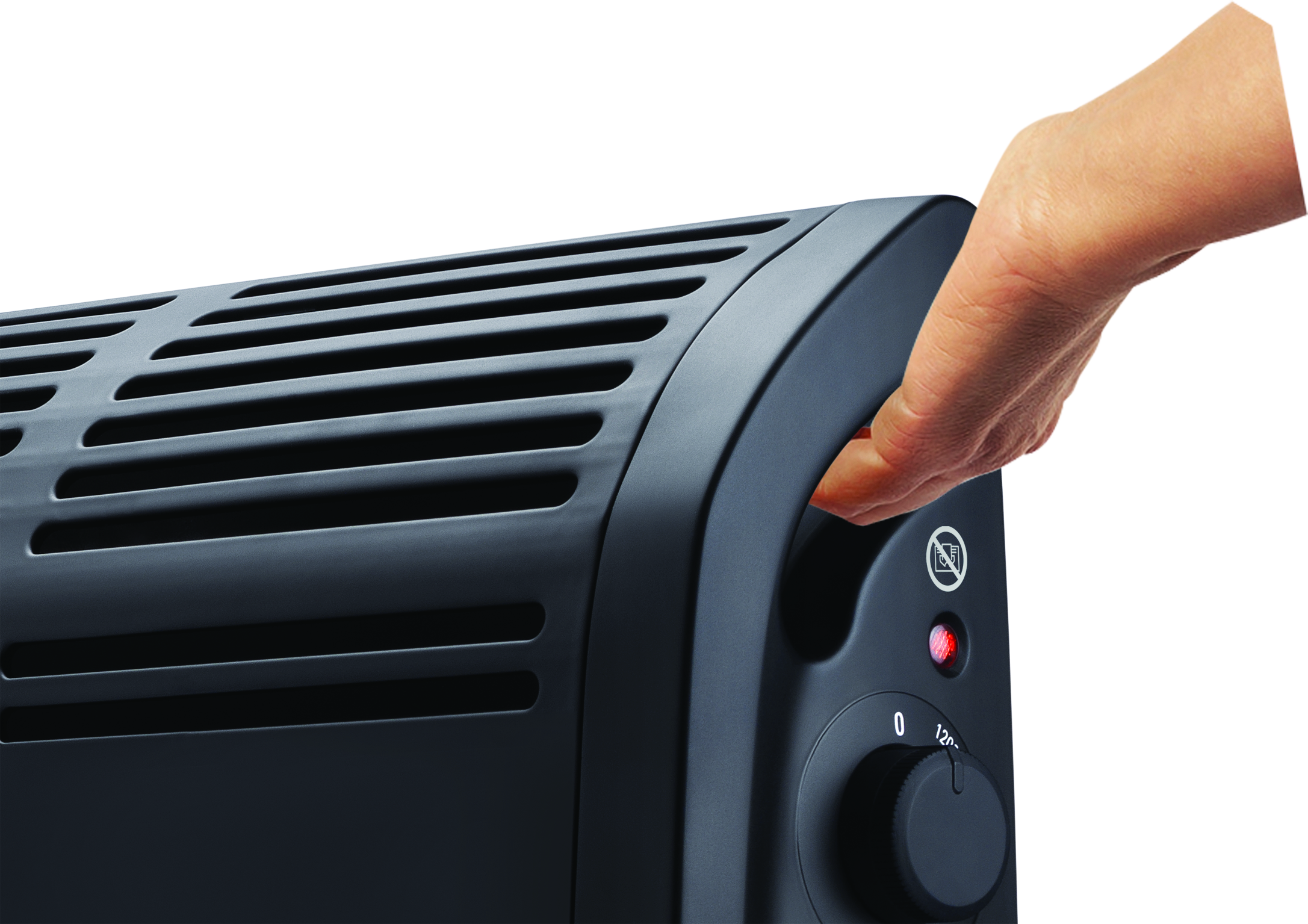 A hand turns the handle of a black electric heater. A red light is on. The control panel has a knob.
