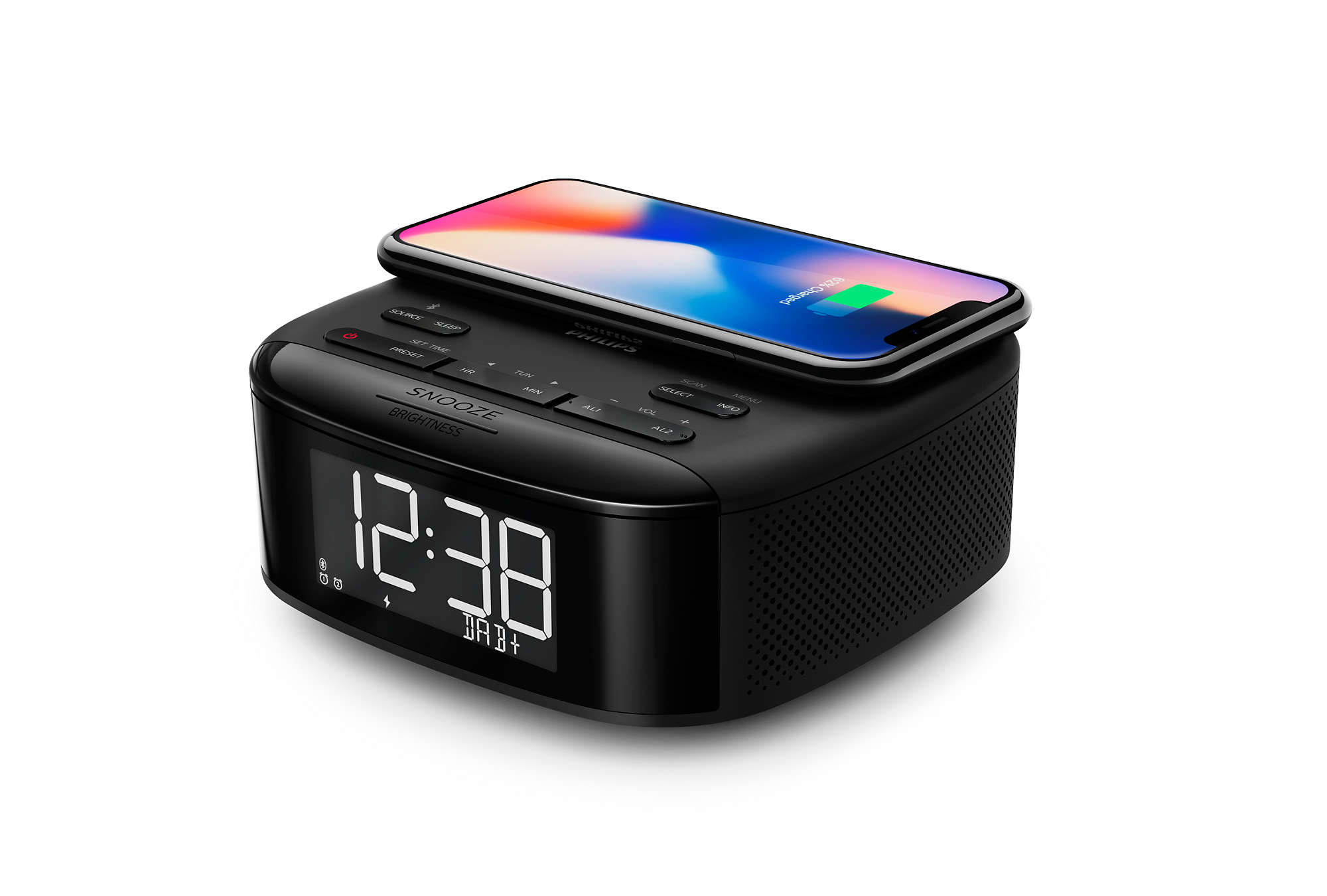 Black alarm clock with a phone charging on top.