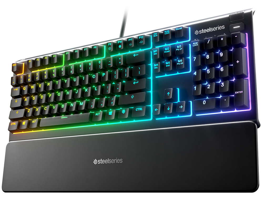 Black SteelSeries keyboard with rainbow-colored keys and a wrist rest. Black background.