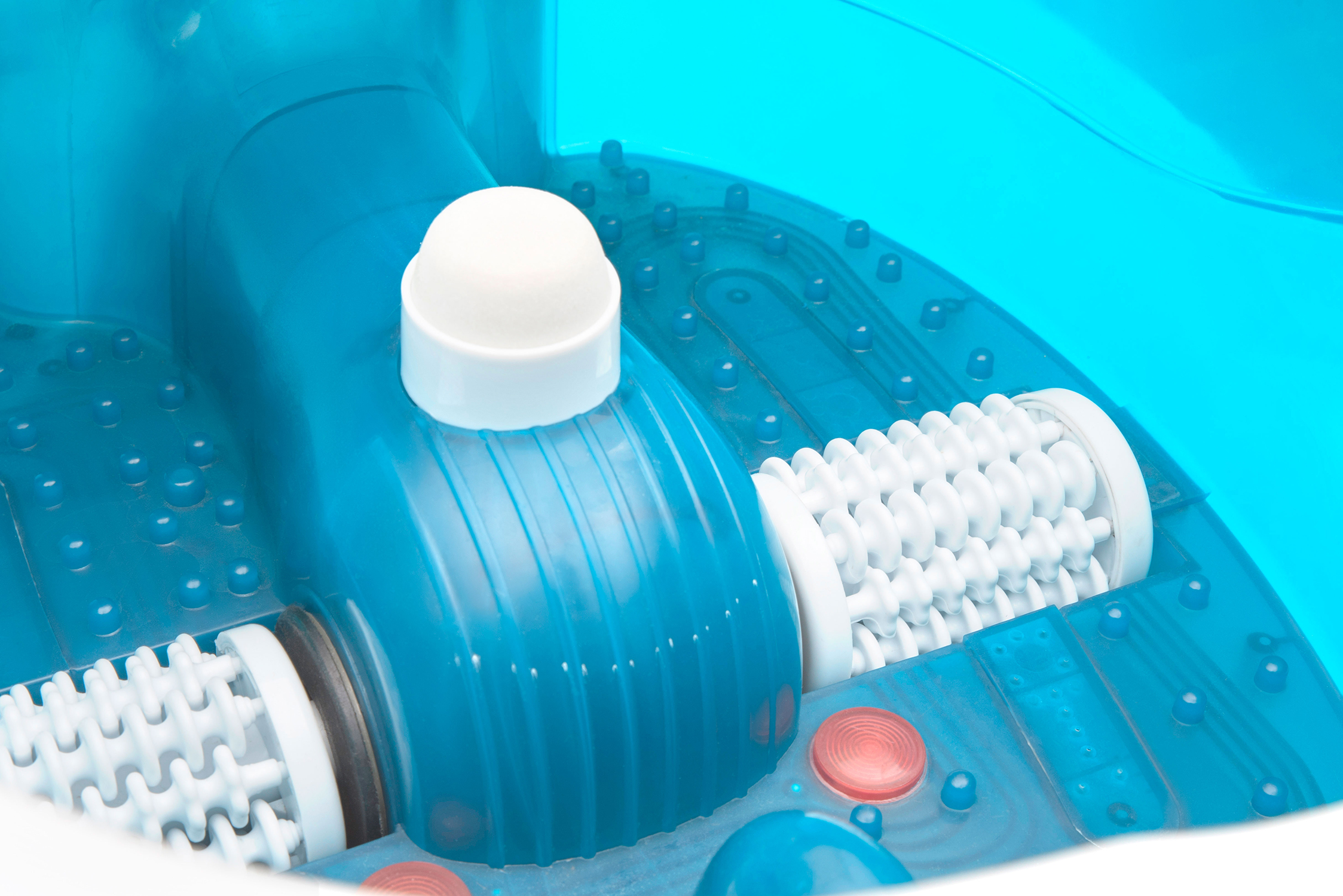 Blue foot spa interior with white rollers, a white knob, and red buttons. The background is a light blue.