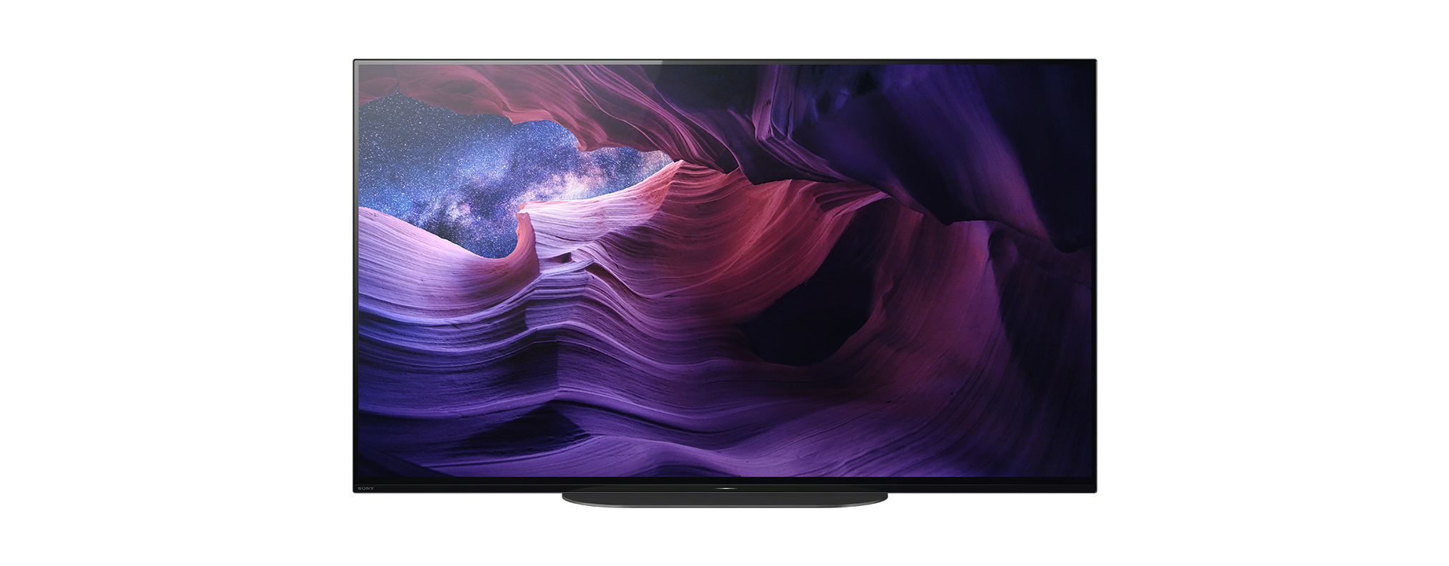 Egy modern TV képernyője, amely egy tájat mutat csillagos égbolttal és sziklaformációkkal.