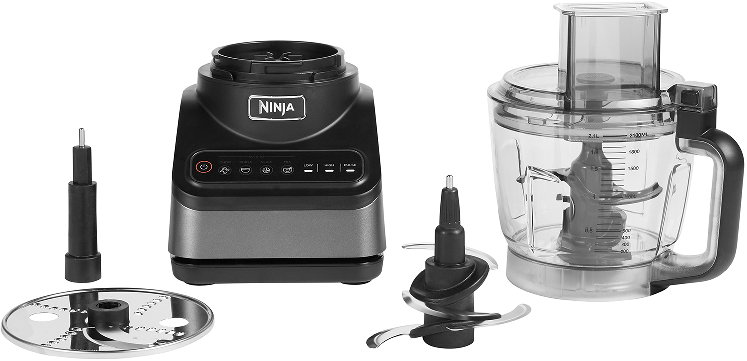 Ninja food processor with accessories. Black base, clear bowl, blades, and attachments.