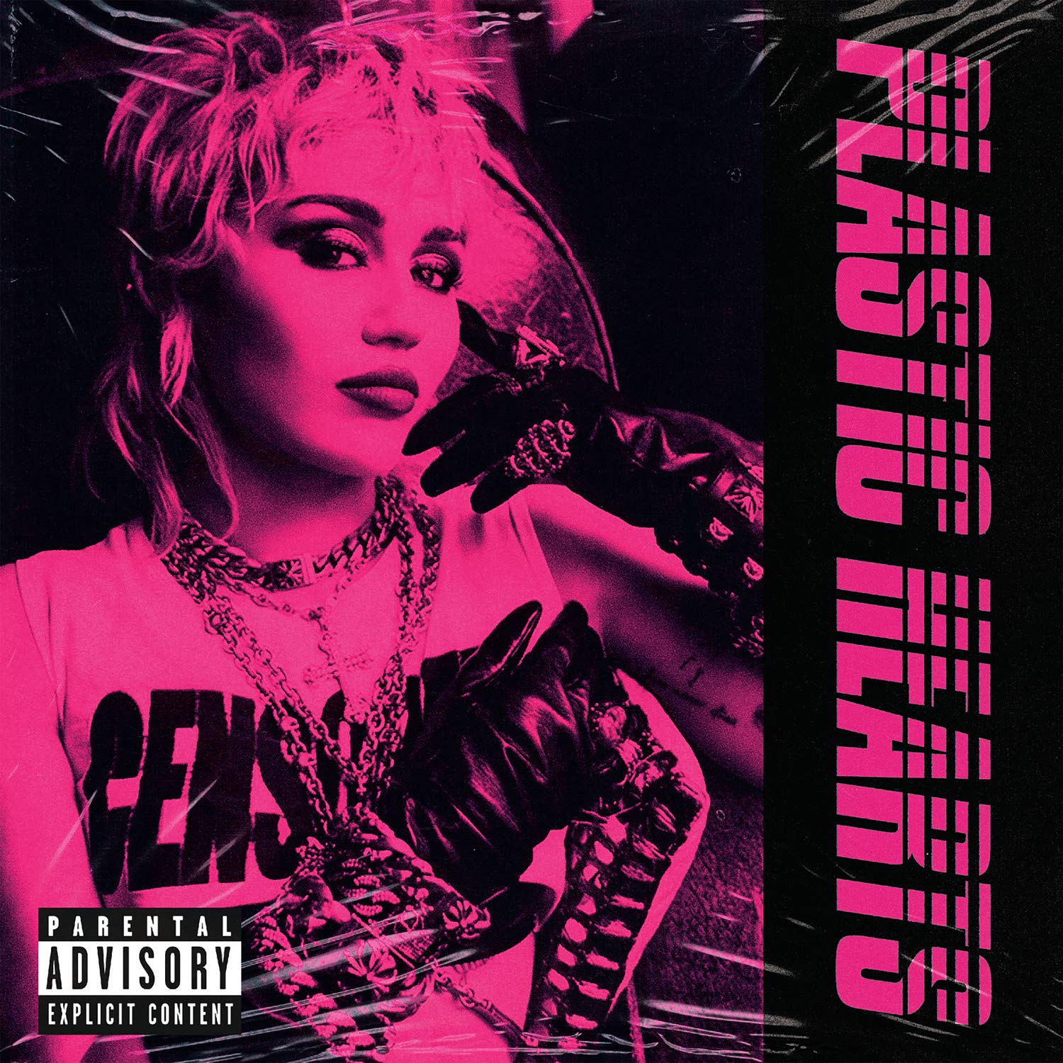 Miley Cyrus album borítója rózsaszínben. Fekete kesztyűket tart.