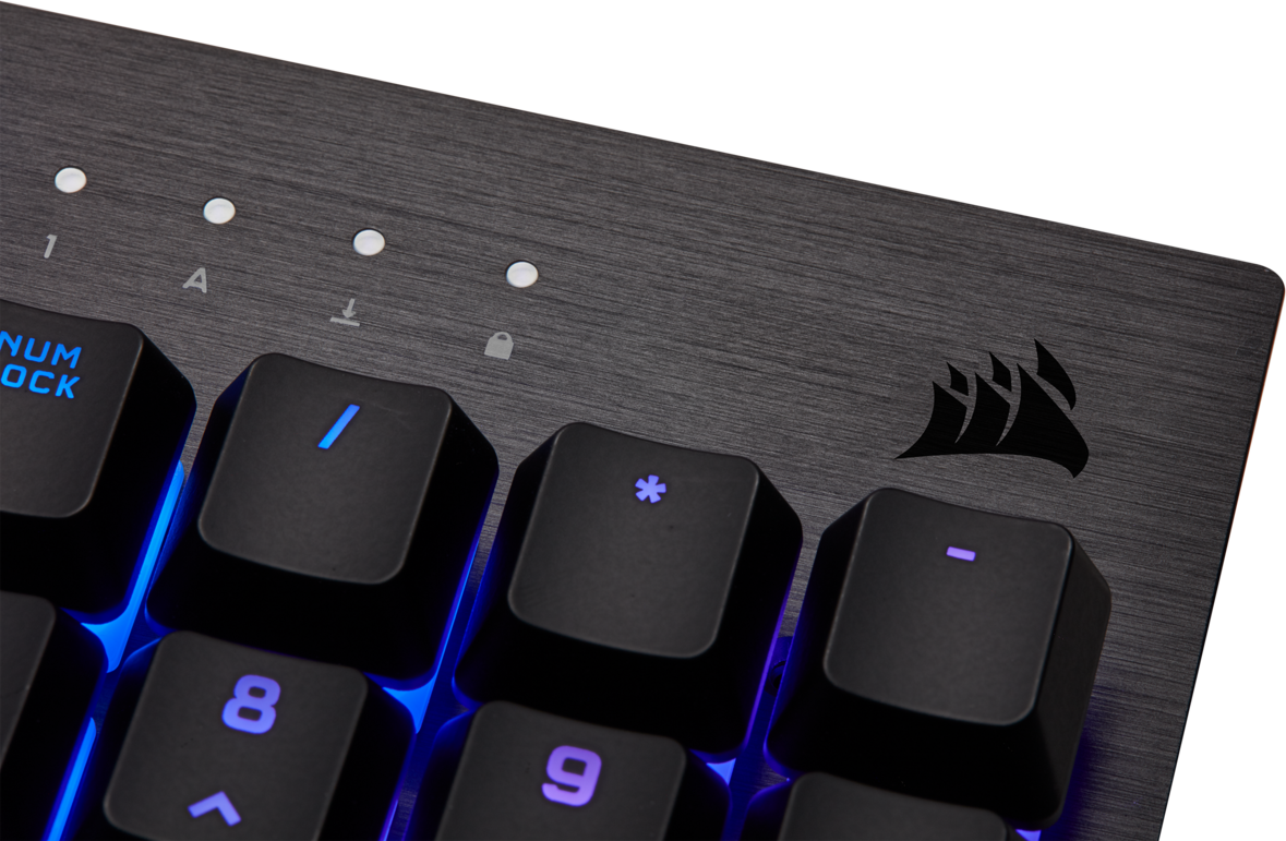 Nahaufnahme einer schwarzen Tastatur mit blauer Hintergrundbeleuchtung. Corsair-Logo sichtbar.