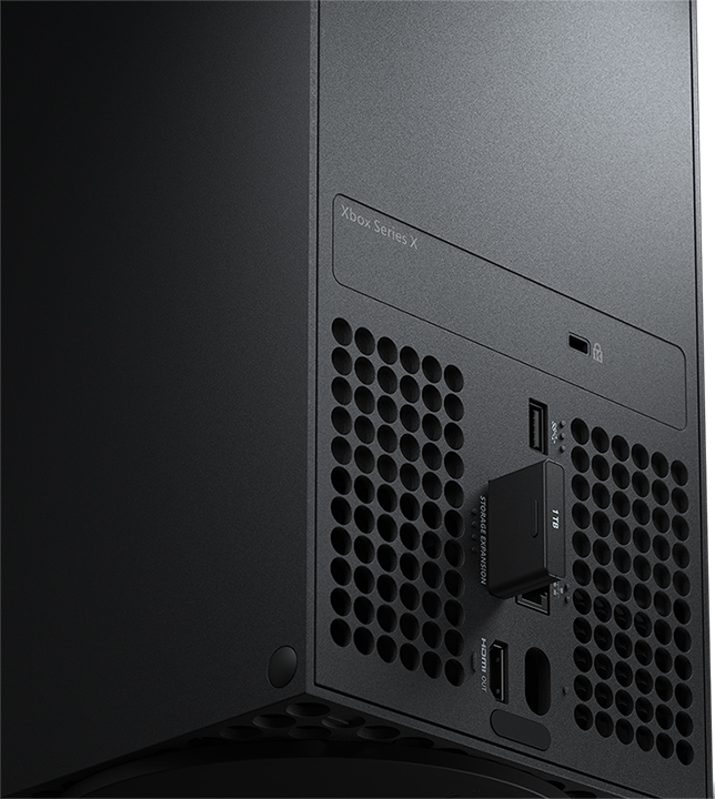 Close-up of the back of an Xbox Series X console with a storage expansion card inserted.