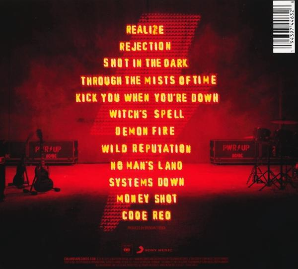 Dos d'une pochette d'album rouge avec titres de chansons en néon rouge. Scène et silhouettes de groupe visibles.