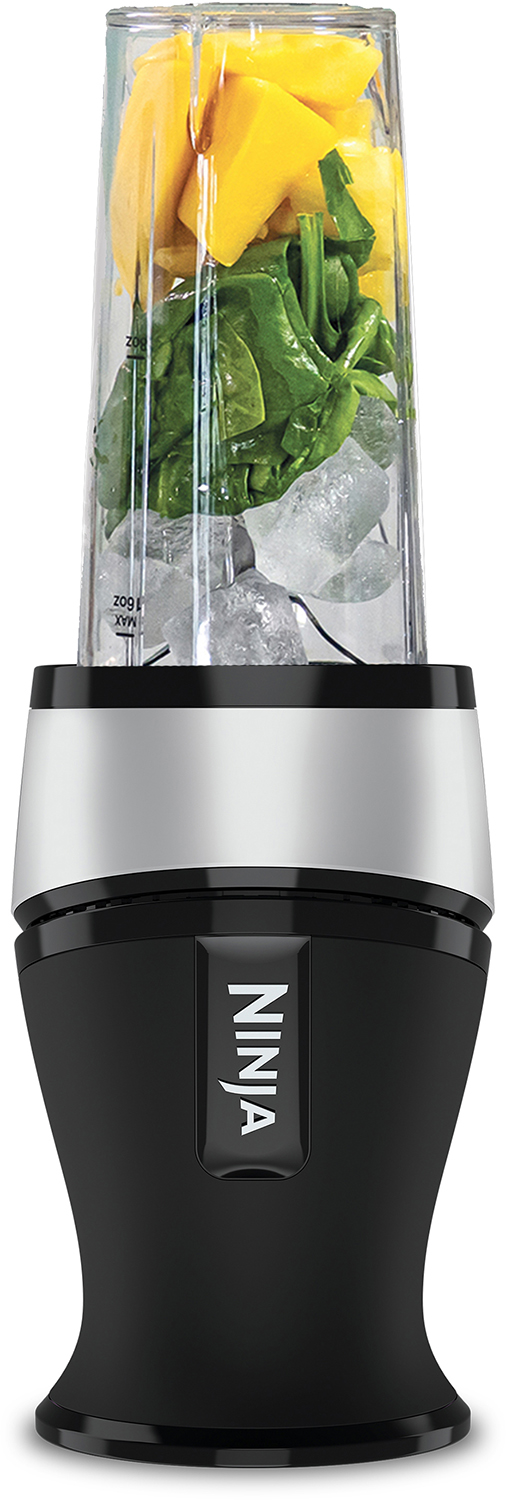 Black and silver blender with ingredients: mango chunks, ice, and spinach.