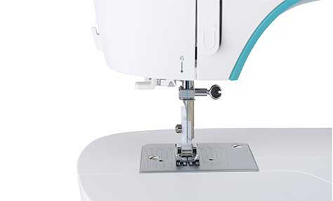 Close-up of a white sewing machine with the needle and presser foot visible.