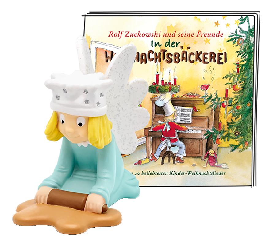 Weihnachtsfigur mit einem Buchcover mit einem Bäcker und einer Weihnachtsszene.