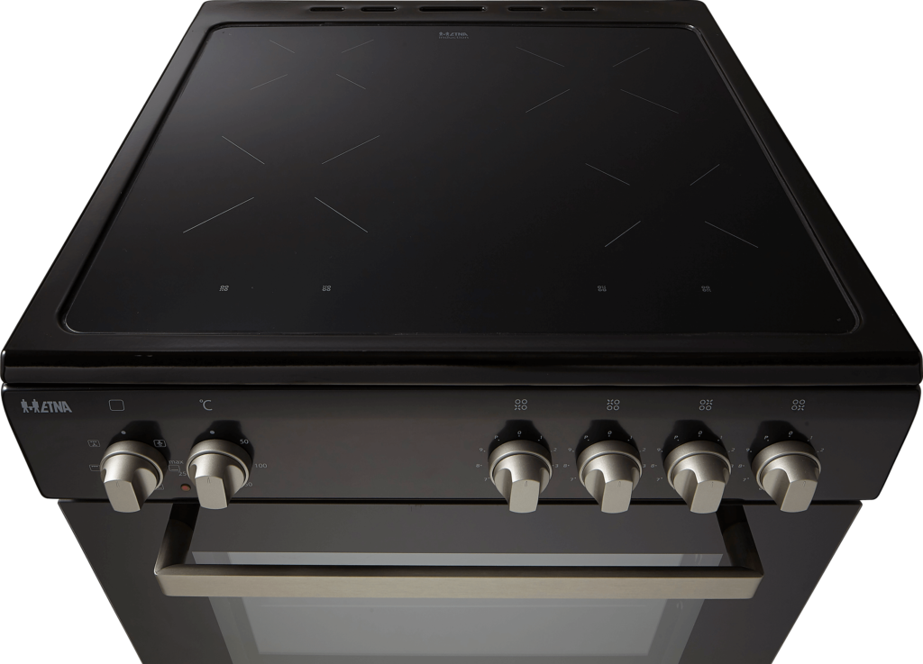 A black electric stove with four induction cooktops and control knobs. The background is dark.