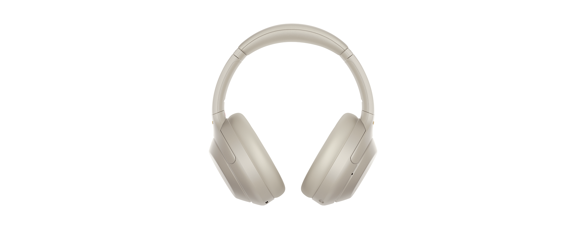 Beige Over-Ear-Kopfhörer vor schwarzem Hintergrund.