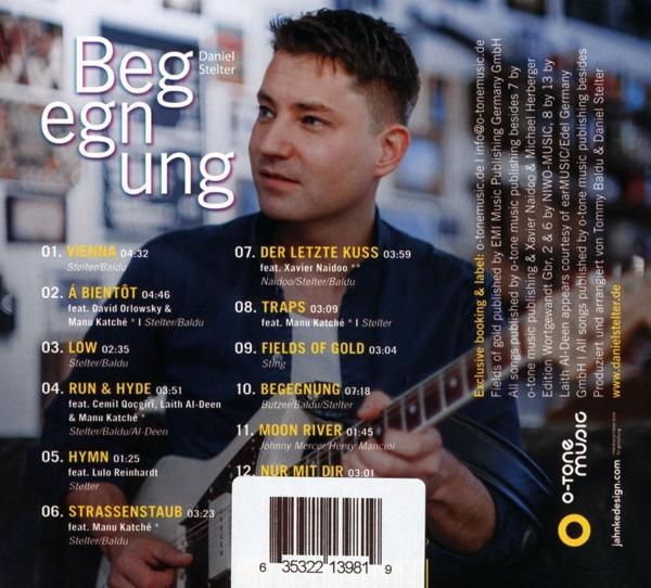 CD-Cover mit Text und Trackliste. Ein Mann hält eine Gitarre und lächelt.