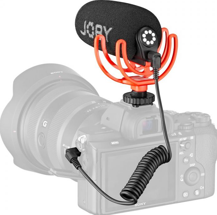 Caméra montée avec un microphone noir et rouge, connecté par un câble enroulé.