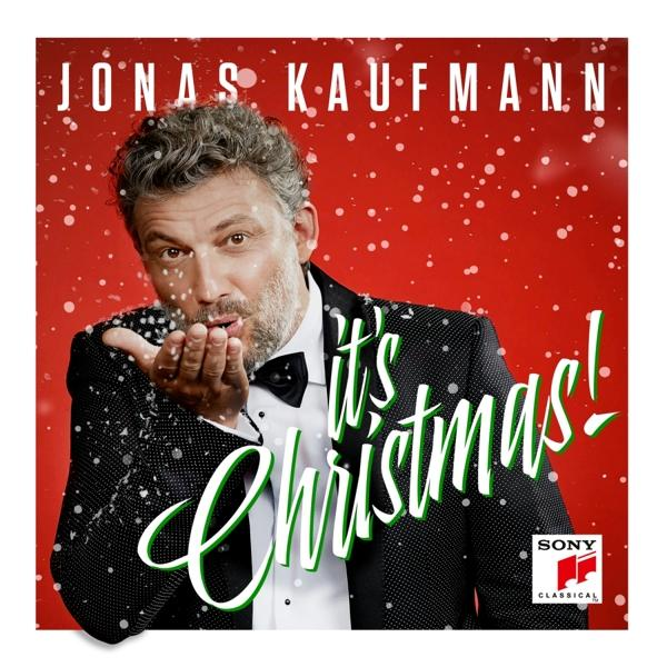 Jonas Kaufmann csillámot fúj, piros háttér, karácsonyi album borító.