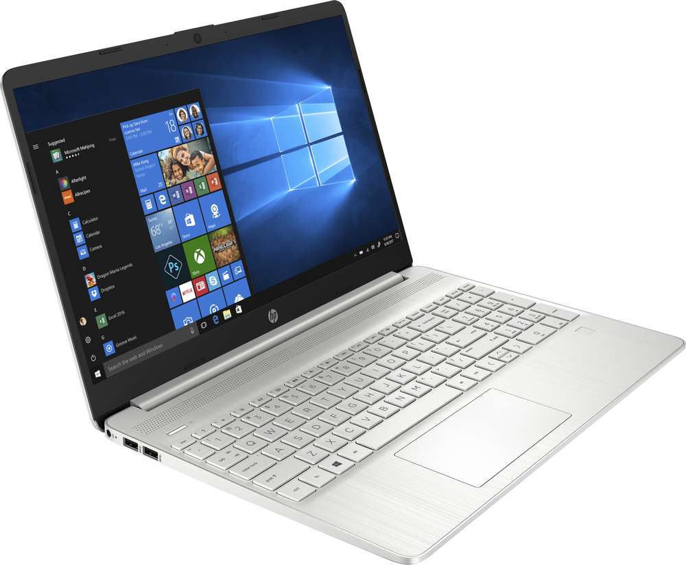 Una computadora portátil plateada abierta sobre una superficie blanca, mostrando la interfaz de Windows 10.